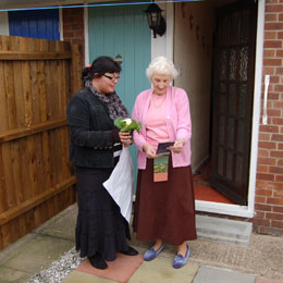 elderly lady receiving flowers  and poster from jodie